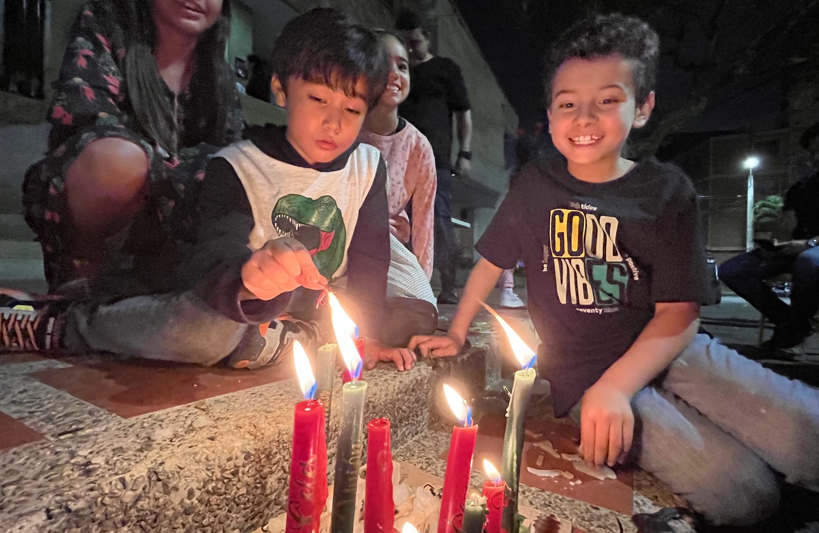 Children light up candles in Medellin Colombia